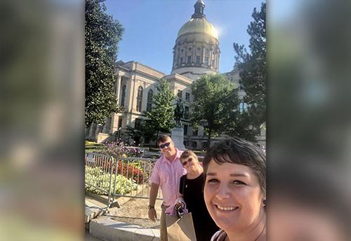 Lacee Landrum and her family pause outside the state capitol on the day 'her' bill was signed into law.